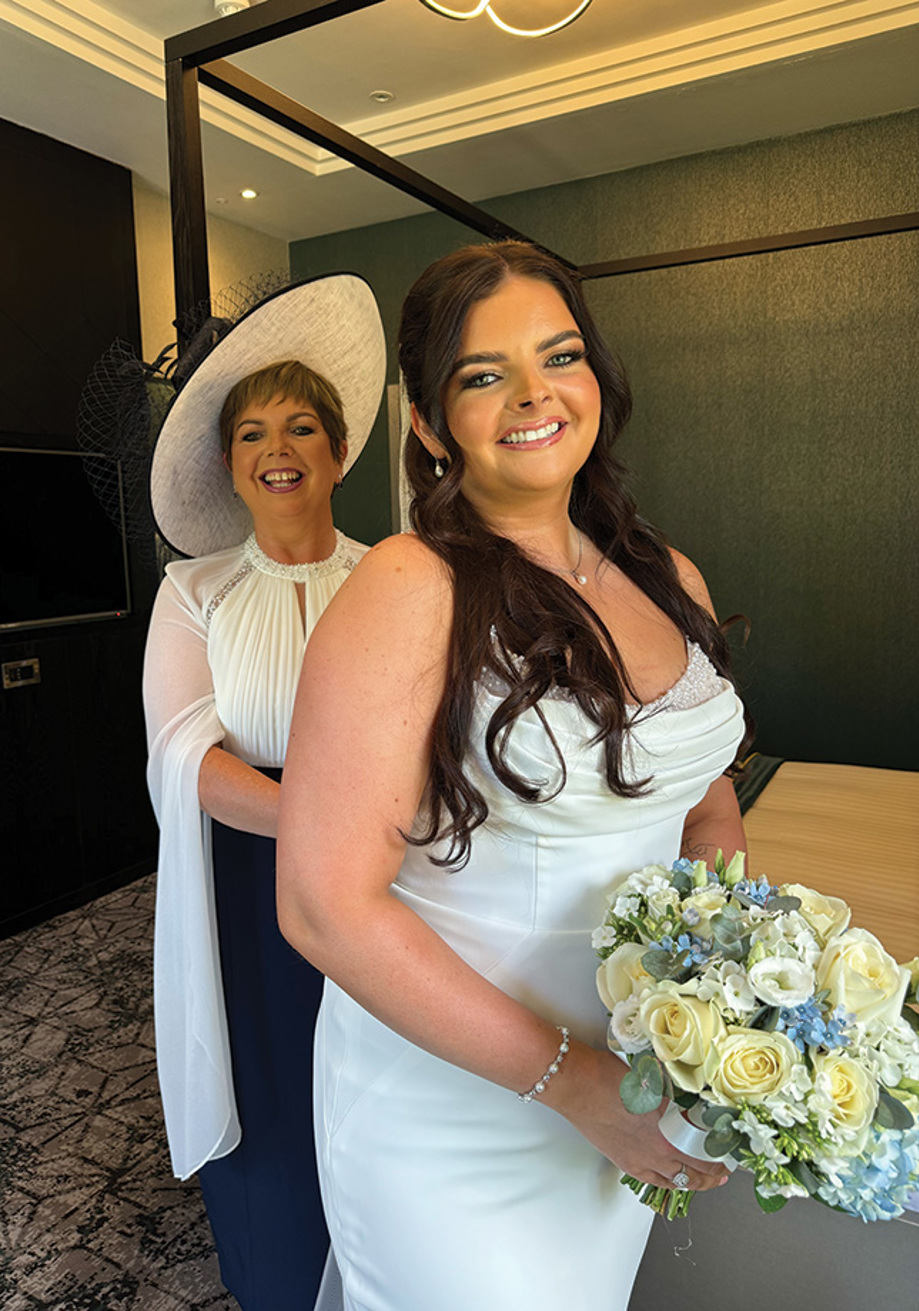 Bride and mother of the bride smile